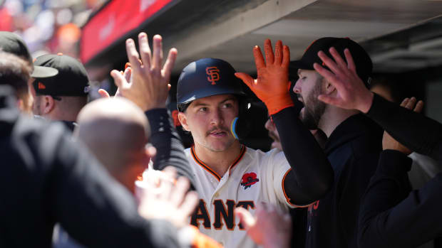 SF Giants catcher Patrick Bailey is congratulated be teammates after scoring a run against the Pittsburgh Pirates on May 29, 2023.