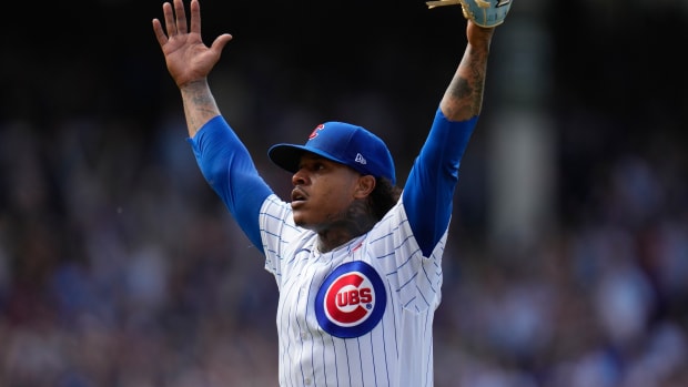 Cubs pitcher Marcus Stroman throws up his hands after pitching a one-hitter