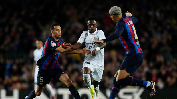 Sergio Busquets (left), Vinicius Junior (center) and Ronald Araujo (right) pictured in action during a Copa del Rey semi-final game between Barcelona and Real Madrid in April 2023