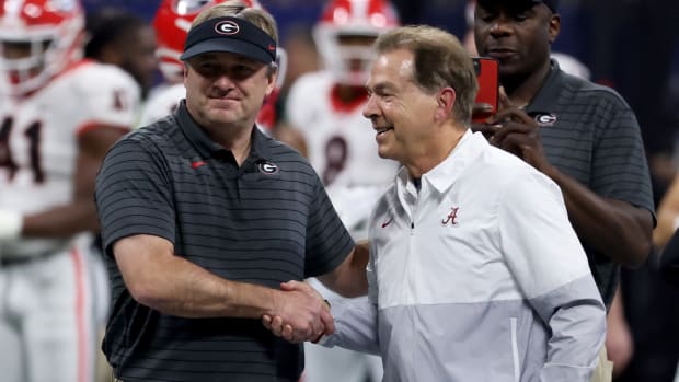 Georgia Bulldogs head coach Kirby Smart greets Alabama Crimson Tide head coach Nick Saban before the SEC championship game.