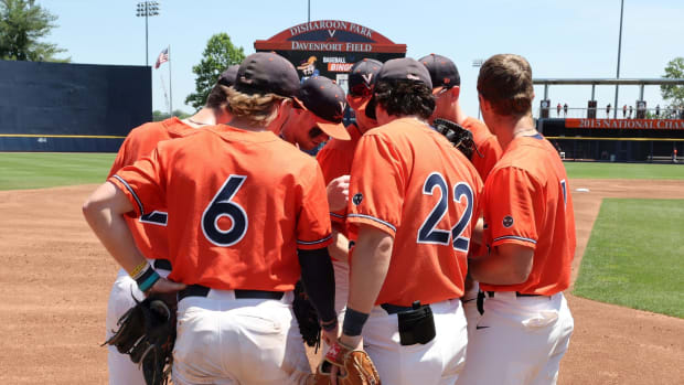 The Virginia baseball team huddles on the mound during the game against Louisville at Disharoon Park.