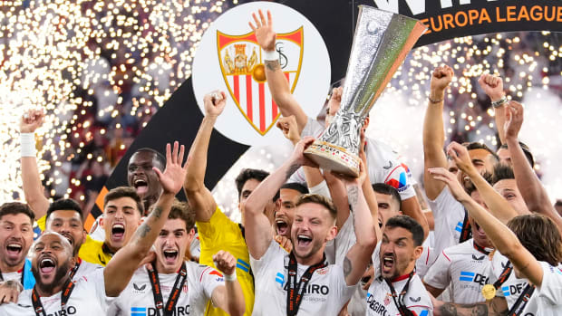 Sevilla's team captain Ivan Rakitic lifts the trophy after winning the Europa League final.