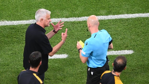 Jose Mourinho pictured (left) gesturing to referee Anthony Taylor during the 2023 Europa League final after the Roma manager had been shown a yellow card