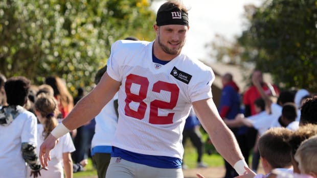 Giants tight end Daniel Bellinger high fives fans during an event in London.