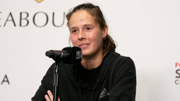Daria Kasatkina sits in front of a microphone