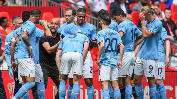 Pep Guardiola discusses strategy and tactics with his Manchester City squad during the 2023 FA Cup final vs. Manchester United.