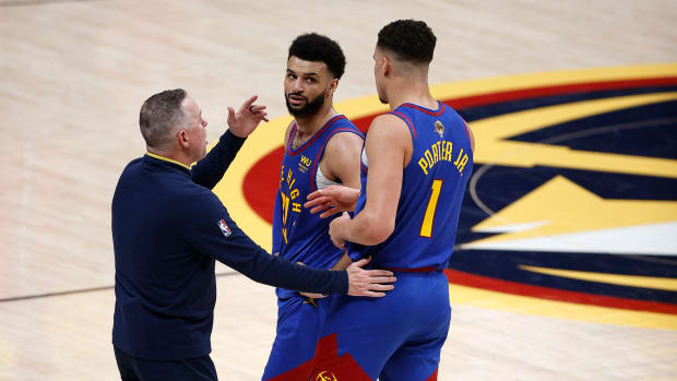 Jun 1, 2023; Denver, CO, USA; Denver Nuggets head coach Michael Malone (left) talks with guard Jamal Murray (27) and forward Michael Porter Jr. (1) during the second half against the Miami Heat in game one of the 2023 NBA Finals at Ball Arena.