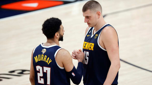 Nuggets center Nikola Jokic and guard Jamal Murray react to a play against the Heat in Game 2 of the NBA Finals.