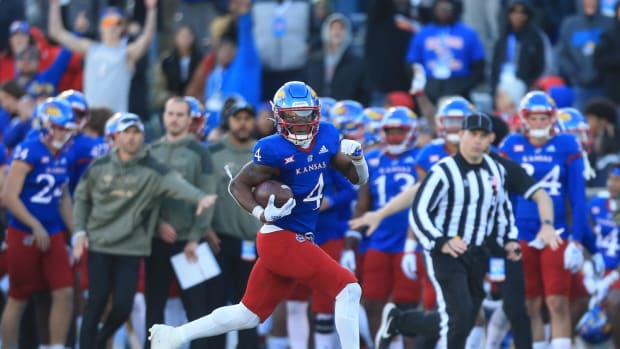 Kansas sophomore running back Devin Neal (4) gains yards in the fourth quarter of Saturday's game against Oklahoma State University at David Booth Kansas Memorial Stadium.