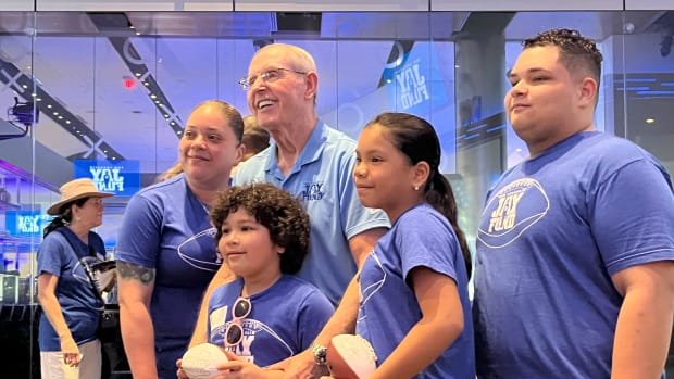 June 9, 2023 - Former New York Giants head coach Tom Coughlin poses with one of the families in attendance at his 2023 TC JAy Fund Sundae Blitz held at MetLife Stadium