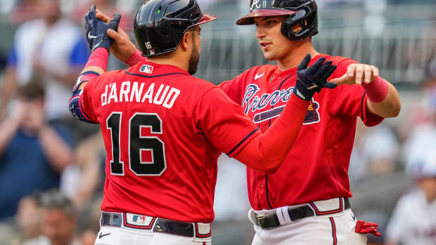 Jun 16, 2023; Cumberland, Georgia, USA; Atlanta Braves catcher Travis d'Arnaud (16) reacts with third baseman Austin Riley (27) after hitting a two run home run against the Colorado Rockies during the first inning at Truist Park. Mandatory Credit: Dale Zanine-USA TODAY Sports