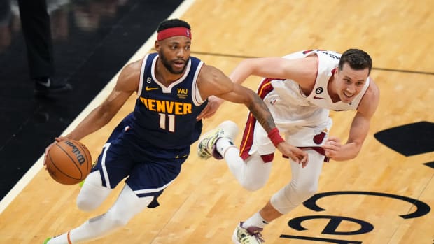 Denver Nuggets forward Bruce Brown (11) dribbles the ball past Miami Heat forward Duncan Robinson (55) during the second half in game four of the 2023 NBA Finals at Kaseya Center.