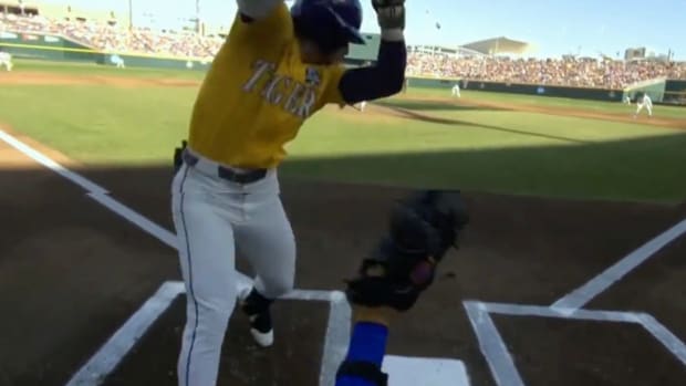 Home plate view of player being hit by pitch
