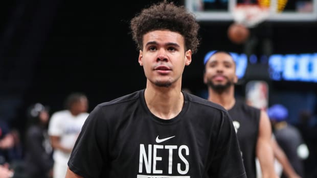 Nets forward Cameron Johnson warms up before a 2023 NBA playoff game.