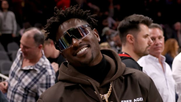 Former NFL star Antonio Brown attends a Hawks game.
