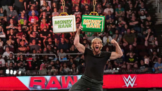 Logan Paul poses with the Money in the Bank briefcase