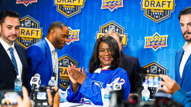 Tennessee State University President Glenda Glover dons a TSU Tigers hockey jersey after becoming the first HBCU to offer men’s ice hockey.