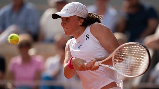Iga Świątek returns a shot during the French Open final against Karolína Muchová.