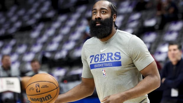 Sixers point guard James Harden prepares to shoot a shot in warmups before a game.
