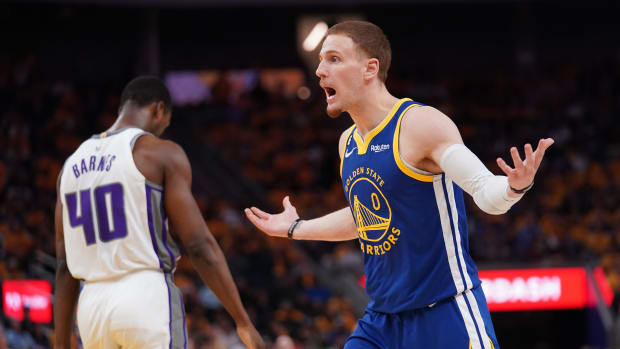 Apr 28, 2023; San Francisco, California, USA; Golden State Warriors guard Donte DiVincenzo (0) reacts after being called for a foul on Sacramento Kings forward Harrison Barnes (40) in the third quarter during game six of the 2023 NBA playoffs at the Chase Center. Mandatory Credit: Cary Edmondson-USA TODAY Sports
