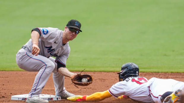 Jul 2, 2023; Cumberland, Georgia, USA; Atlanta Braves right fielder Ronald Acuna Jr. (13) steals second base under Miami Marlins shortstop Joey Wendle (18) during the first inning at Truist Park.