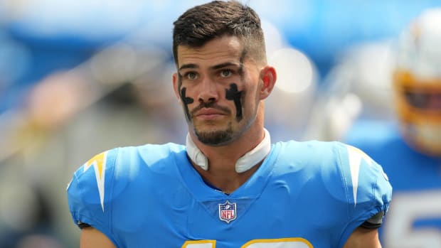 Chargers linebacker Drue Tranquill looks on without a helmet during a game.