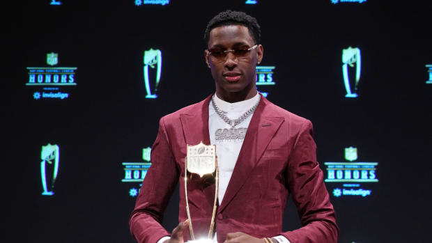 Jets' CB Sauce Gardner holds the 2022 NFL DROTY trophy