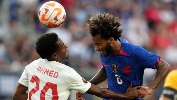 United States midfielder Gianluca Busio (6) heads the ball as Canada midfielder Ali Ahmed (20) defends during the first half of a Gold Cup quarterfinal match between the United States and Canada.
