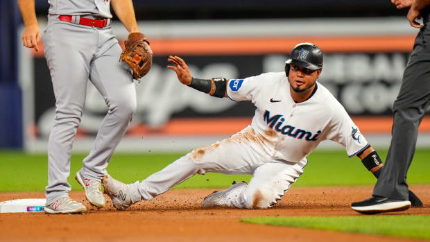 Jul 6, 2023; Miami, Florida, USA; Miami Marlins second baseman Luis Arraez (3) slides into second base against the St. Louis Cardinals during the first inning at loanDepot Park.