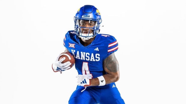 Devin Neal wears the new blue uniforms unveiled by the Kansas Jayhawks on July 10, 2023.