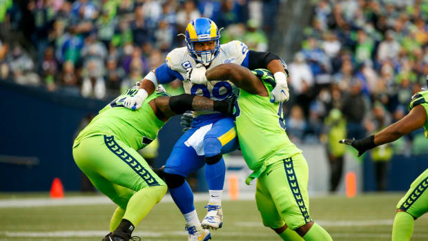Oct 7, 2021; Seattle, Washington, USA; Los Angeles Rams defensive end Aaron Donald (99) is blocked by Seattle Seahawks offensive tackle Duane Brown (76, left) and guard Damien Lewis (68, right) during the second quarter at Lumen Field. Mandatory Credit: Joe Nicholson-USA TODAY Sports