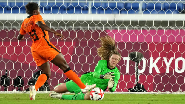 United States goalkeeper Alyssa Naeher dives for the ball as Netherlands forward Lineth Beerensteyn makes a play for it during the quarterfinals during the Tokyo Olympics.