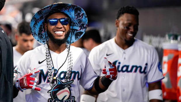 Jul 9, 2023; Miami, Florida, USA; Miami Marlins left fielder Bryan De La Cruz (14) celebrates in the dug out after hitting a home run against the Philadelphia Phillies during the third inning at loanDepot Park.