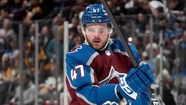 Former Avalanche forward Alex Galchenyuk adjusts his pads during a game.