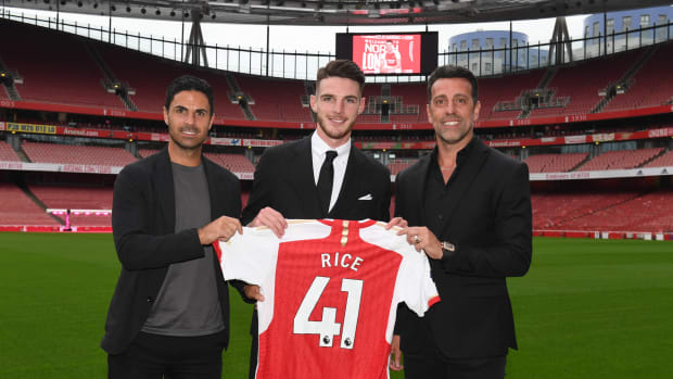 Declan Rice pictured (center) alongside Arsenal manager Mikel Arteta (left) and sporting director Edu (right) after completing a £105 million transfer from West Ham in July 2023
