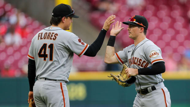 SF Giants third baseman Wilmer Flores (41) high fives right fielder Mike Yastrzemski (5) after a win at Great American Ball Park (2023)