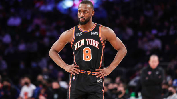 Knicks point guard Kemba Walker looks on with his hands on his hips during a game.