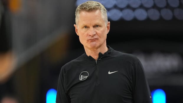 Warriors head coach Steve Kerr looks on while coaching during a game.