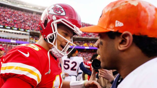 Kansas City Chiefs quarterback Patrick Mahomes (15) talks with Denver Broncos quarterback Russell Wilson (3) after a game at GEHA Field at Arrowhead Stadium.