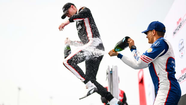 Josef Newgarden tries to jump out of the way of Alex Palou's champagne shower after winning Sunday's IndyCar race at Iowa Speedway, sweeping the two-race weekend series. Photo courtesy IndyCar.