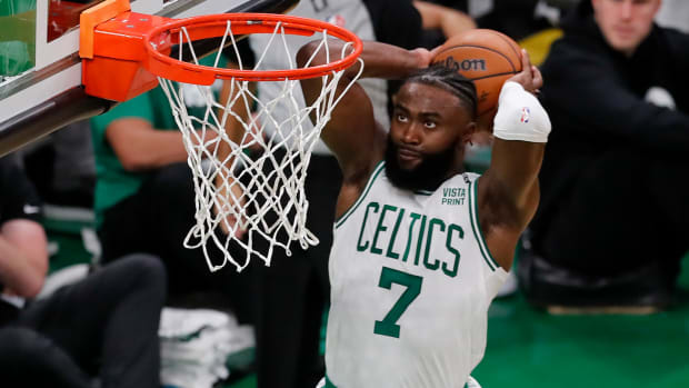 Celtics' Jaylen Brown dunks the ball against the Warriors.