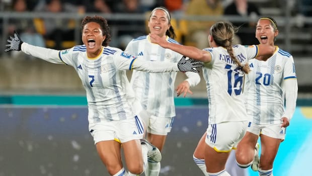 Philippines players celebrate after Sarina Bolden's goal