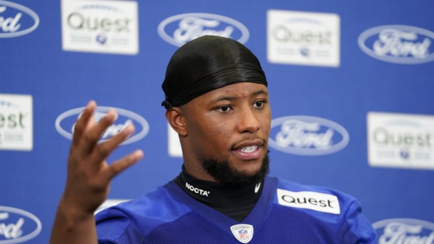 Giants running back Saquon Barkley said he had an "epiphany" and decided not to hold out and report for training camp.