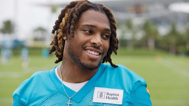Dolphins cornerback Jalen Ramsey smiles while looking on during a practice.