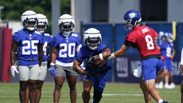 Jul 26, 2023; East Rutherford, NJ, USA; New York Giants quarterback Daniel Jones (8) hands the ball to running back Saquon Barkley (26) on the first day of training camp at the Quest Diagnostics Training Facility.