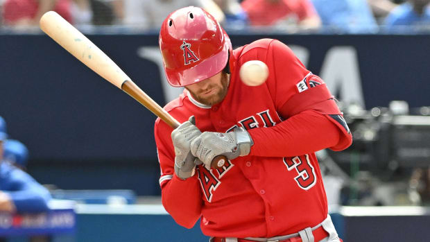 Angels outfielder Taylor Ward takes a pitch to the face during an at-bat.