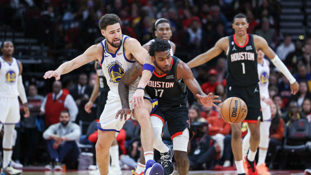 Mar 20, 2023; Houston, Texas, USA; Houston Rockets forward Tari Eason (17) gets control of the ball as Golden State Warriors guard Klay Thompson (11) defends during the fourth quarter at Toyota Center. Mandatory Credit: Troy Taormina-USA TODAY Sports