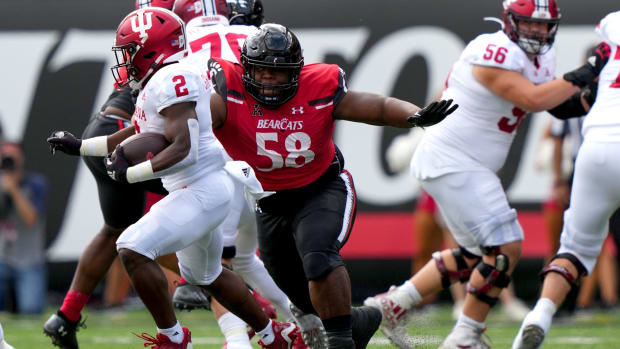 Cincinnati Bearcats defensive lineman Dontay Corleone (58) tackles Indiana Hoosiers running back Shaun Shivers (2) in the first quarter of a college football game, Saturday, Sept. 24, 2022, at Nippert Stadium in Cincinnati. Ncaaf Indiana Hoosiers At Cincinnati Bearcats Sept 24 0219