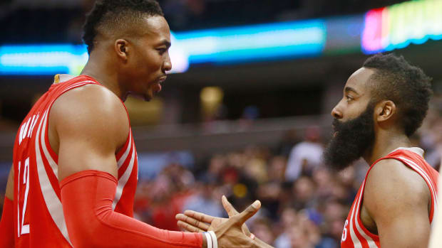 Dec 17, 2014; Denver, CO, USA; Houston Rockets guard James Harden (right) celebrates with Houston Rockets center Dwight Howard (left) after scoring with 10.4 seconds left in the fourth quarter against the Denver Nuggets at Pepsi Center. The Rockets won 115-111 in overtime. Mandatory Credit: Chris Humphreys-USA TODAY Sports