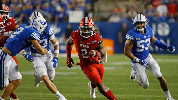 Aug 29, 2019; Provo, UT, USA; Utah Utes running back Zack Moss (2) runs against Brigham Young Cougars defensive back Austin Lee (2) in the first quarter at LaVell Edwards Stadium. Mandatory Credit: Jeff Swinger-USA TODAY Sports
